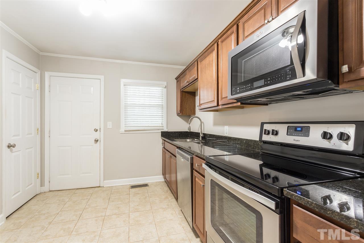 2732 Knowles Street Raleigh, NC 27603 - Photo 8 of 26 a kitchen with a stove and a microwave