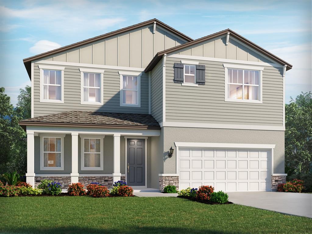 a front view of a house with a yard and trees