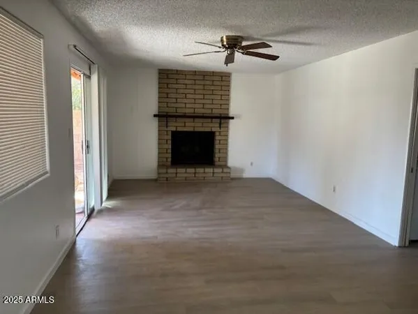 a view of an empty room with a fireplace