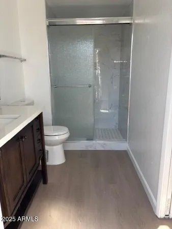 a bathroom with a shower a toilet and a sink