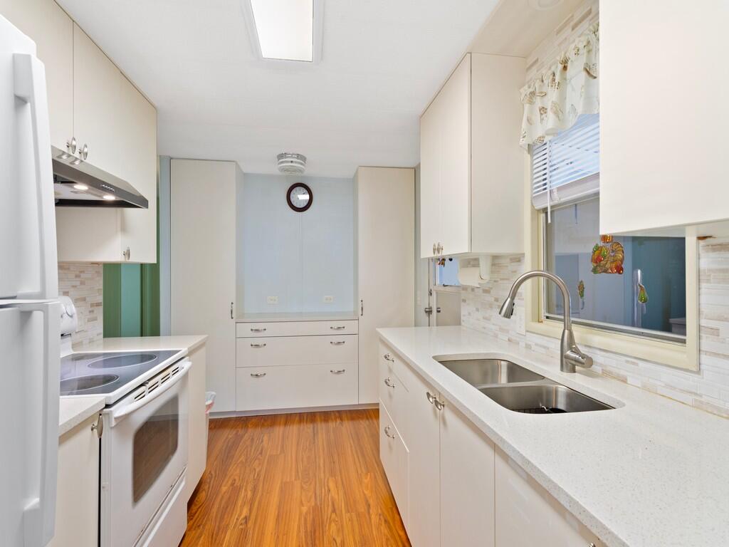 4800 Southeast Federal Highway, Unit 93 Stuart, FL 34997 - Photo 11 of 25 a kitchen with a sink stove and cabinets