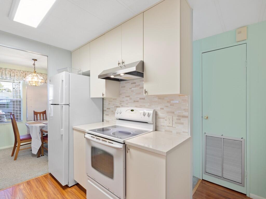 4800 Southeast Federal Highway, Unit 93 Stuart, FL 34997 - Photo 12 of 25 a kitchen with a stove and a refrigerator