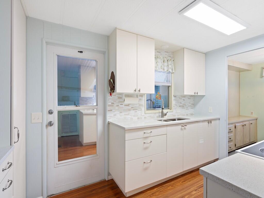4800 Southeast Federal Highway, Unit 93 Stuart, FL 34997 - Photo 13 of 25 a bathroom with a granite countertop sink mirror and double