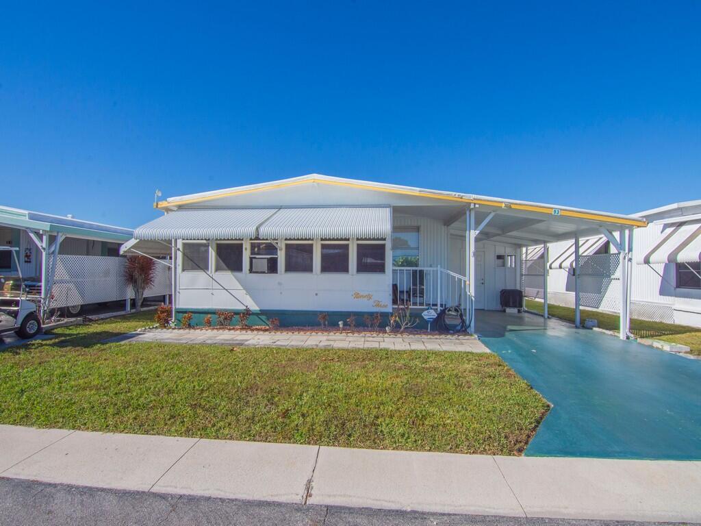 4800 Southeast Federal Highway, Unit 93 Stuart, FL 34997 - Photo 2 of 25 a view of a house with a swimming pool
