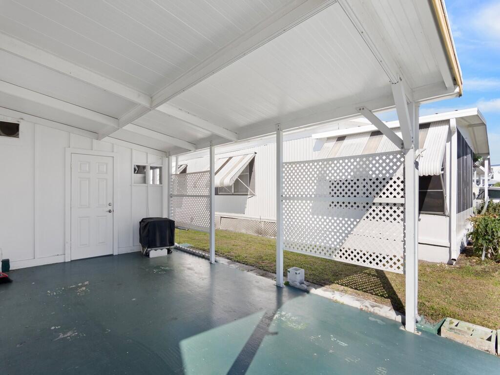 4800 Southeast Federal Highway, Unit 93 Stuart, FL 34997 - Photo 5 of 25 a view of a livingroom with wooden floor a ceiling fan and windows
