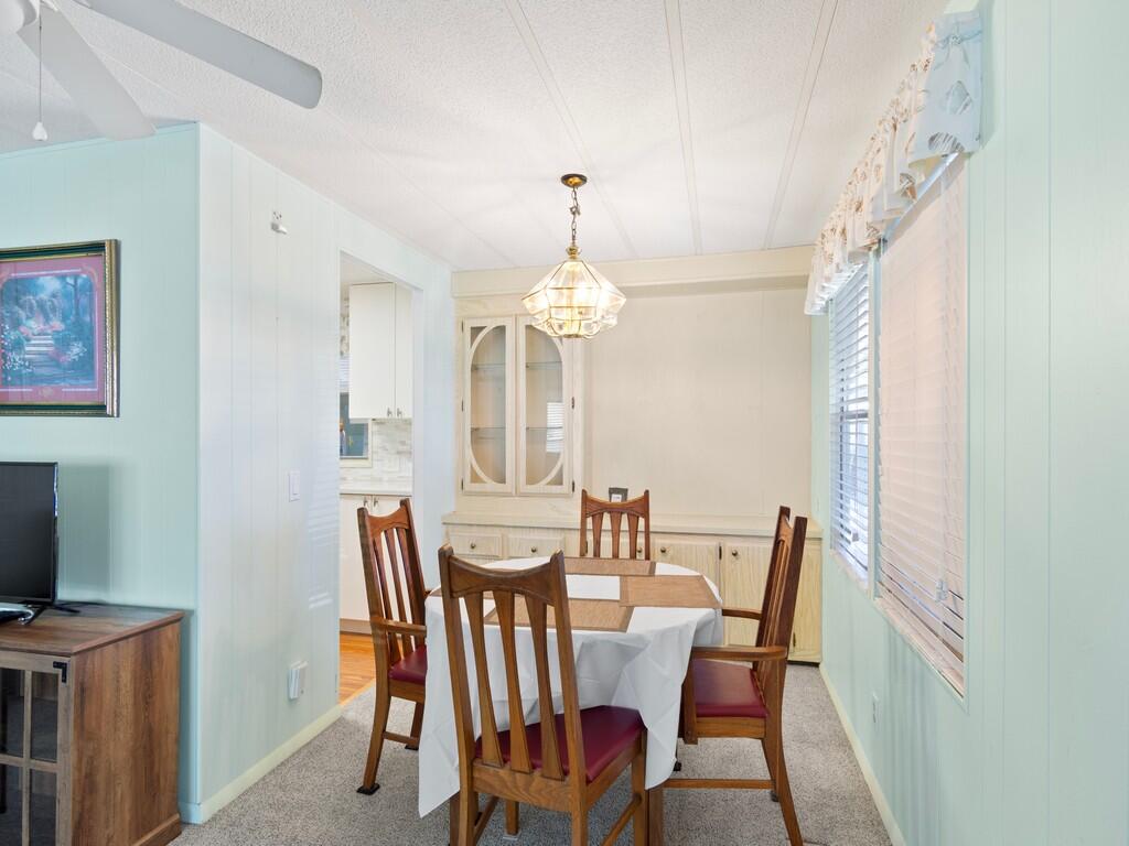4800 Southeast Federal Highway, Unit 93 Stuart, FL 34997 - Photo 10 of 25 a view of a dining room with furniture window and wooden floor