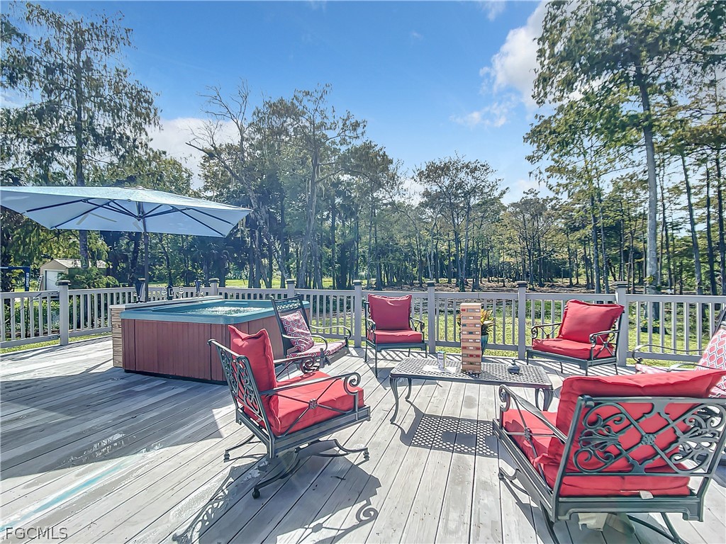 2511 6th Street Northwest Naples, FL 34120 - Photo 36 of 39 an outdoor sitting area with furniture and wooden deck