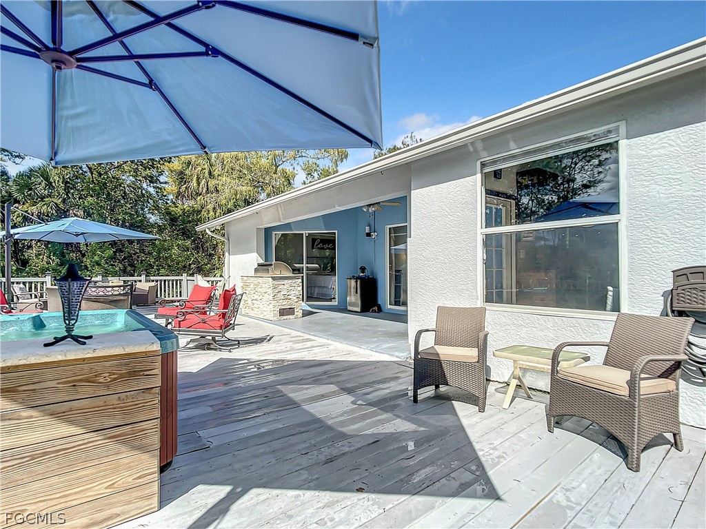 2511 6th Street Northwest Naples, FL 34120 - Photo 37 of 39 a chair and tables in the patio