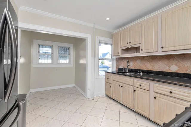 a kitchen with granite countertop white cabinets and stainless steel appliances