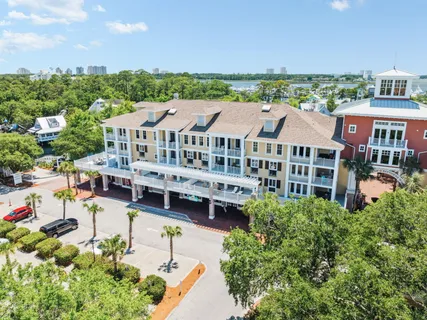 an aerial view of multiple houses with a yard