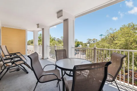 a balcony view with a seating space