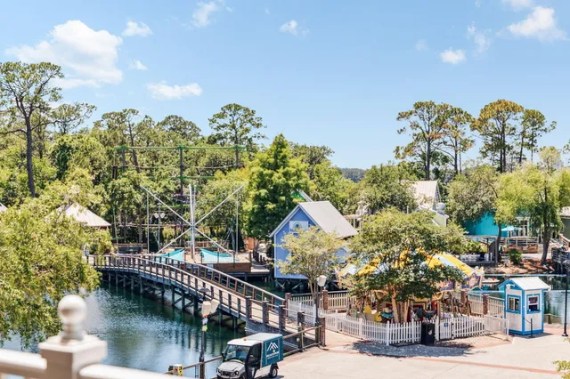 a view of a staircase and dinning table under an umbrella