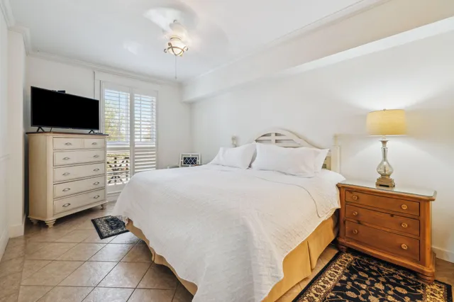 a bedroom with a bed and flat screen tv