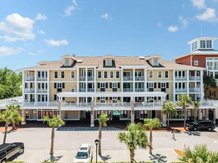 a front view of a building with street view and sitting space