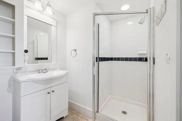 a bathroom with a shower sink and mirror