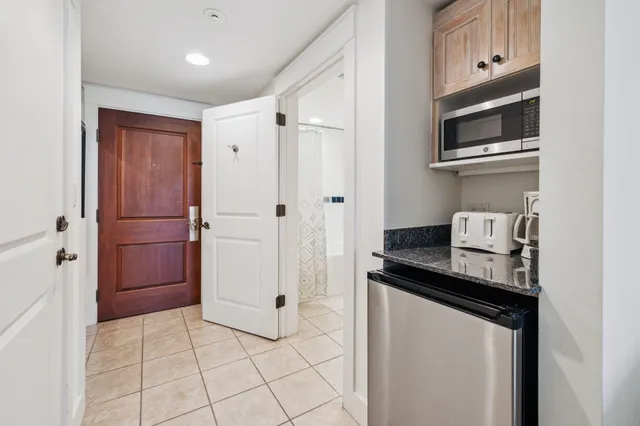 a kitchen with stainless steel appliances granite countertop a refrigerator and a microwave