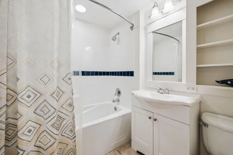 a bathroom with a bathtub sink mirror and toilet