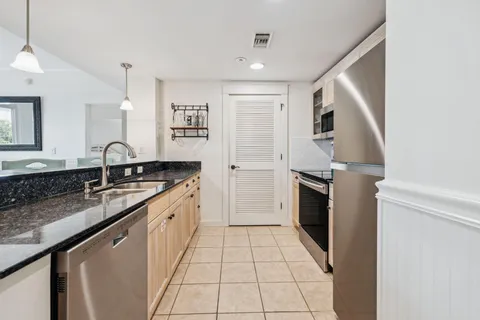 a kitchen with a sink stove and refrigerator