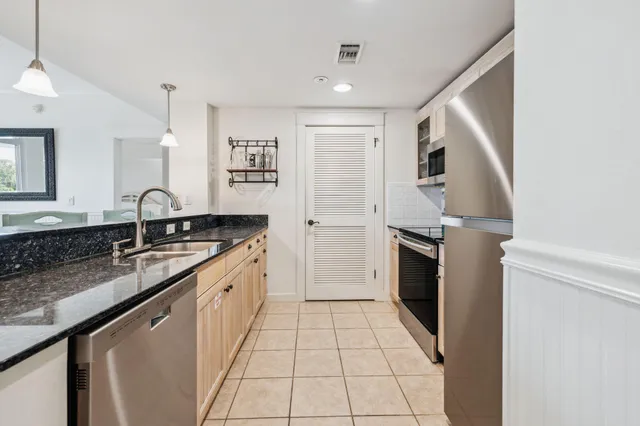 a kitchen with a sink stove and refrigerator