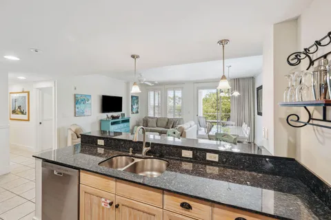 a kitchen with counter top space and living room view