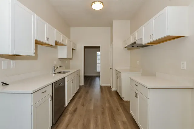 a kitchen with cabinets a sink and appliances