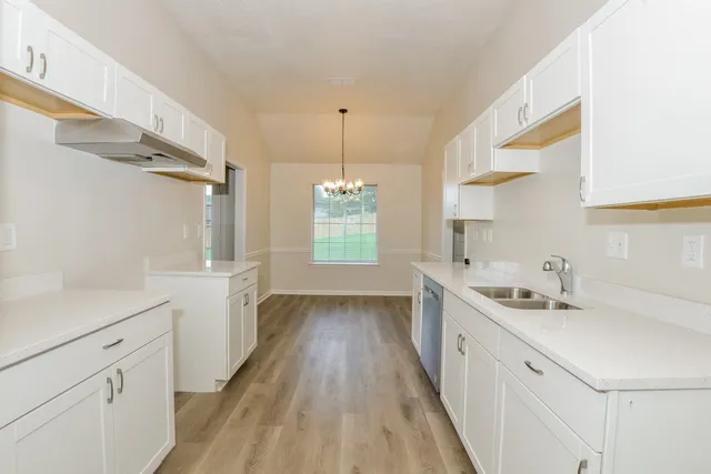 a bathroom with a sink a large mirror and a shower