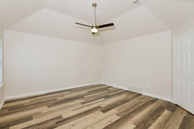 a view of a room with a sink and wooden floor