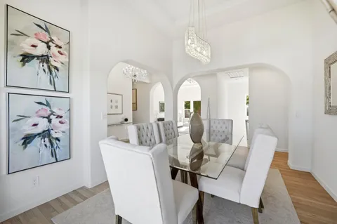 a view of a dining room with furniture and wooden floor