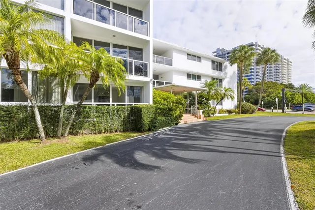 a view of hallway with wooden floor and chandelier
