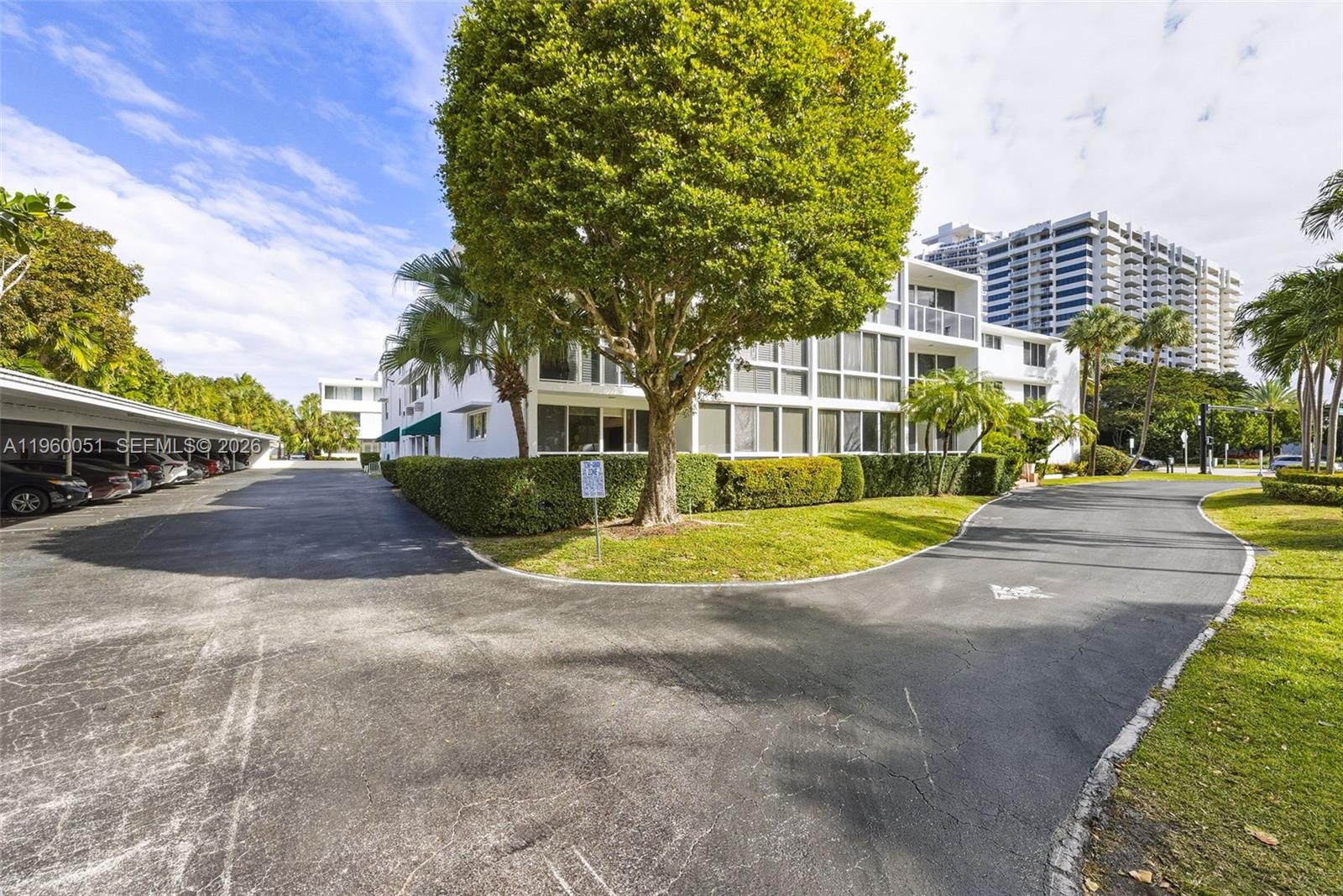 1 Harbour Way, Unit 108 Bal Harbour, FL 33154 - Photo 23 of 27 a view of a white house with a swimming pool and yard