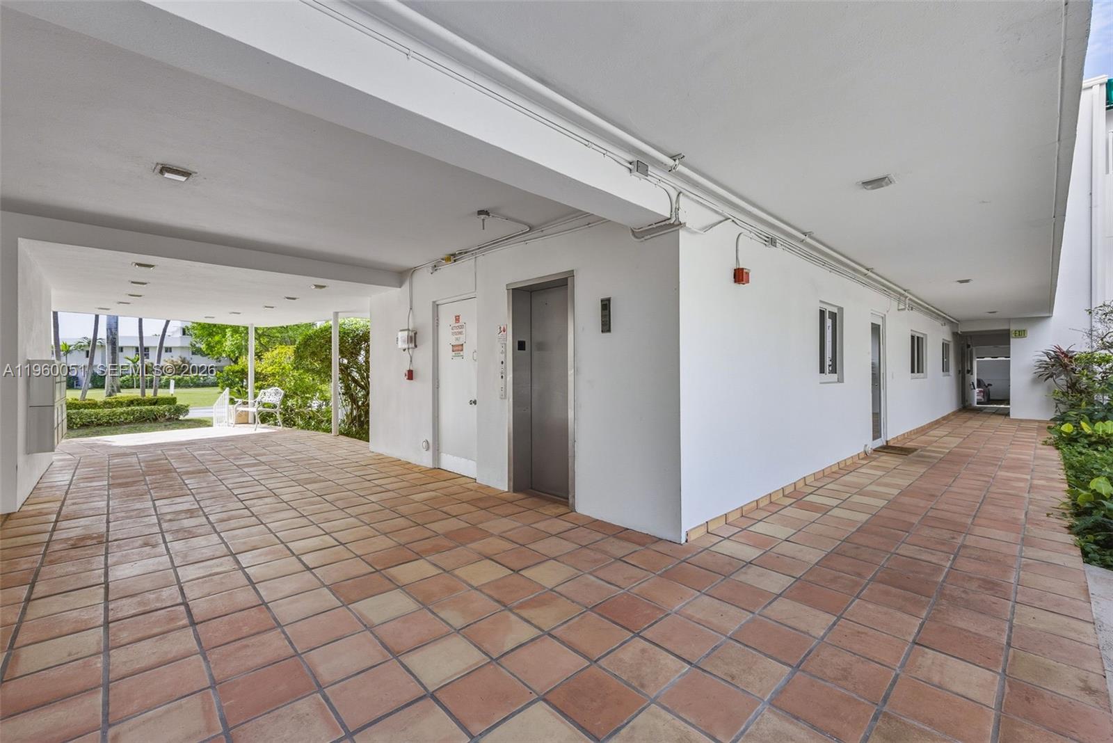 1 Harbour Way, Unit 108 Bal Harbour, FL 33154 - Photo 24 of 27 a view of hallway with wooden floor and chandelier