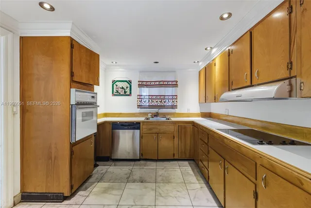 a view of a kitchen with a sink and cabinets