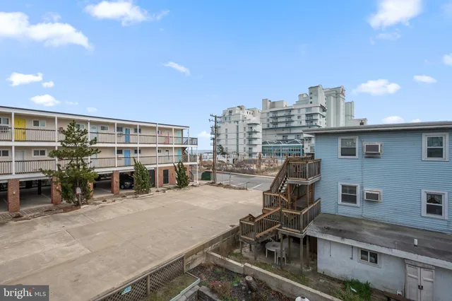 a view of a wooden deck and a backyard