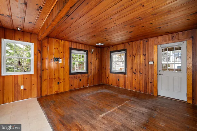 a view of a room with a wooden door