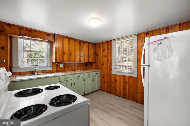 a view of walk in closet with wooden floor