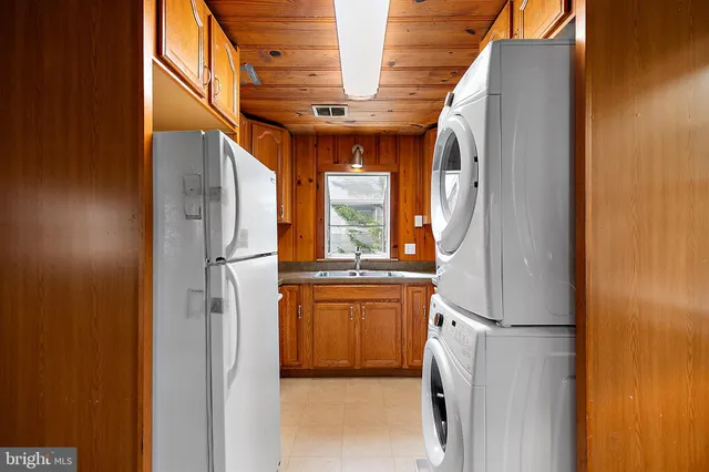 a kitchen with a sink and a refrigerator
