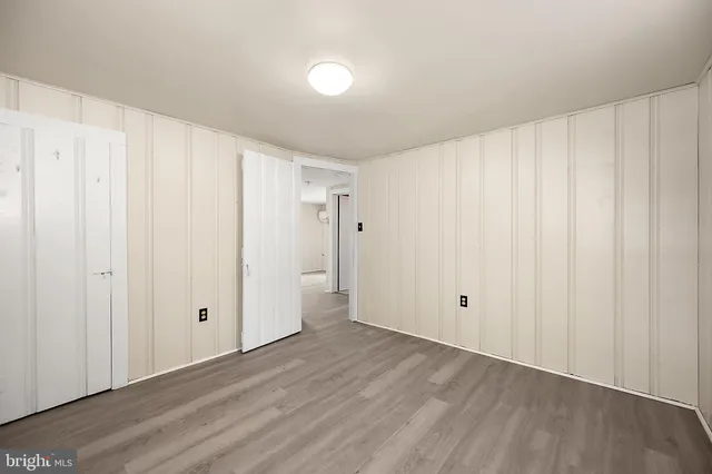 a house with tall trees in front of it