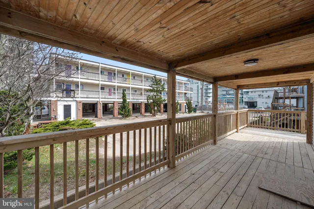 a view of a balcony with wooden floor