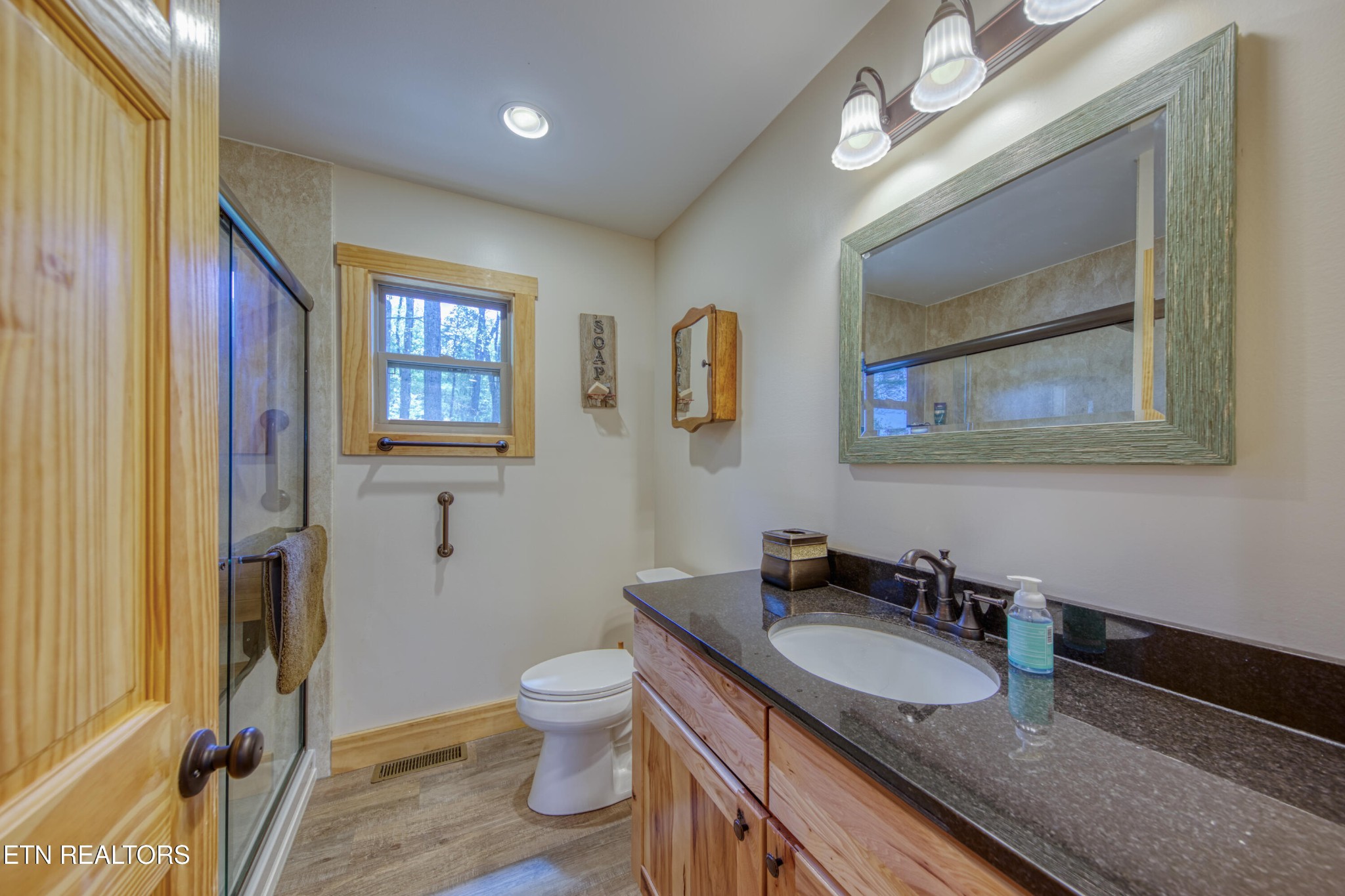 1040 Rdg Pt Trail Dandridge, TN 37725 - Photo 22 of 31 a bathroom with a granite countertop double vanity sink a mirror and a toilet