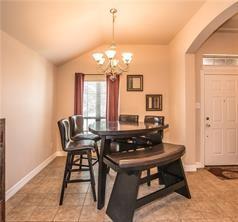 1409 Rosson Road Little Elm, TX 75068 - Photo 19 of 34 Dining area featuring a vaulted ceiling with a chandelier, tile flooring, and a large window with vertical blinds