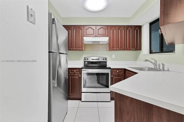 a kitchen with a sink cabinets and stainless steel appliances