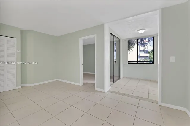 an empty room with entrance and windows