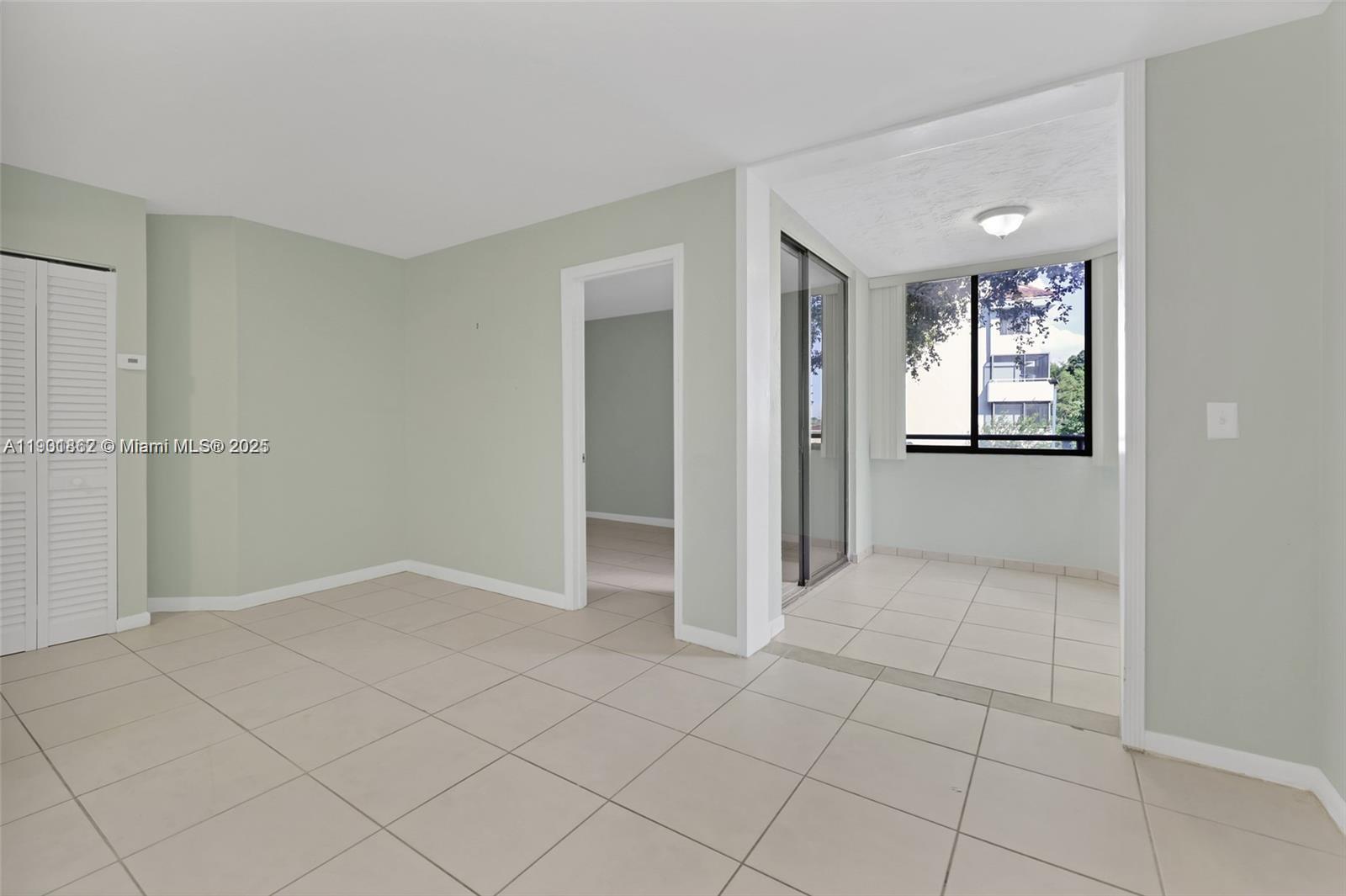 8335 Southwest 152nd Avenue, Unit B203 Miami, FL 33193 - Photo 9 of 10 an empty room with entrance and windows