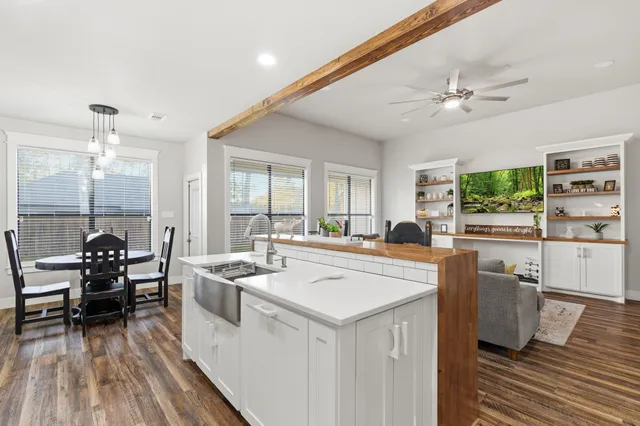a kitchen with a stove a chandelier and a refrigerator