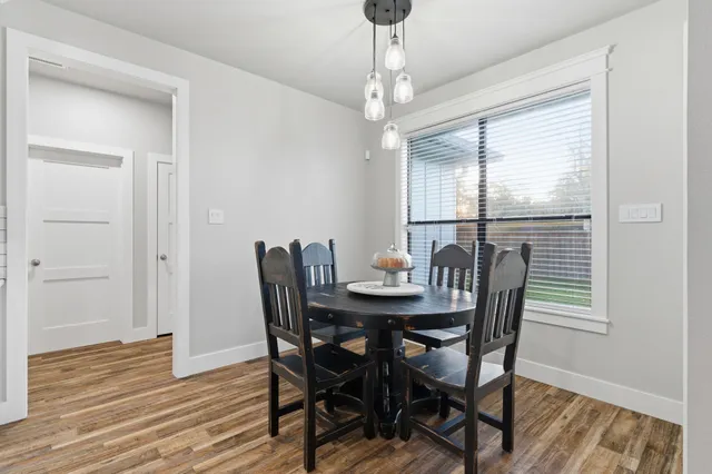 a view of a dining room with furniture window and wooden floor