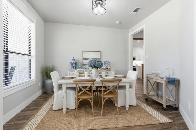 a view of a dining room with furniture and window