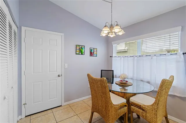 a bedroom with a bed a chandelier and a window