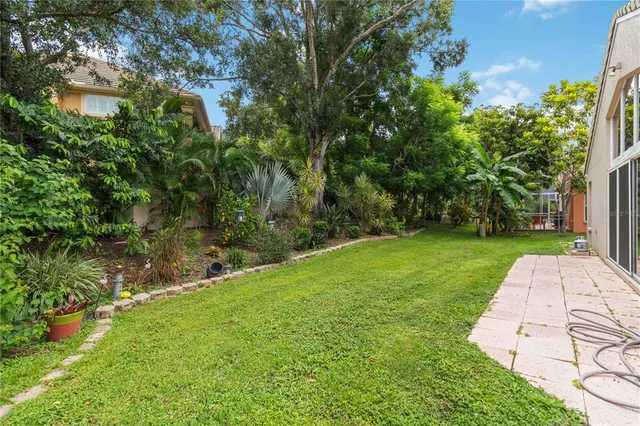 a view of backyard of house with green space