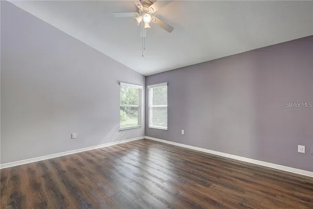a view of a kitchen with wooden floor and a window