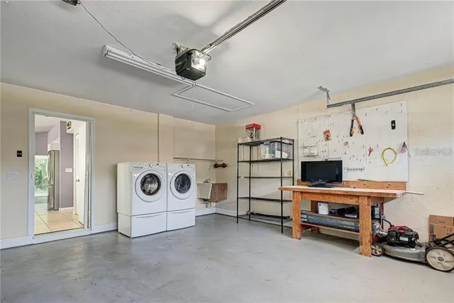 a kitchen with stainless steel appliances kitchen island granite countertop a refrigerator and a sink
